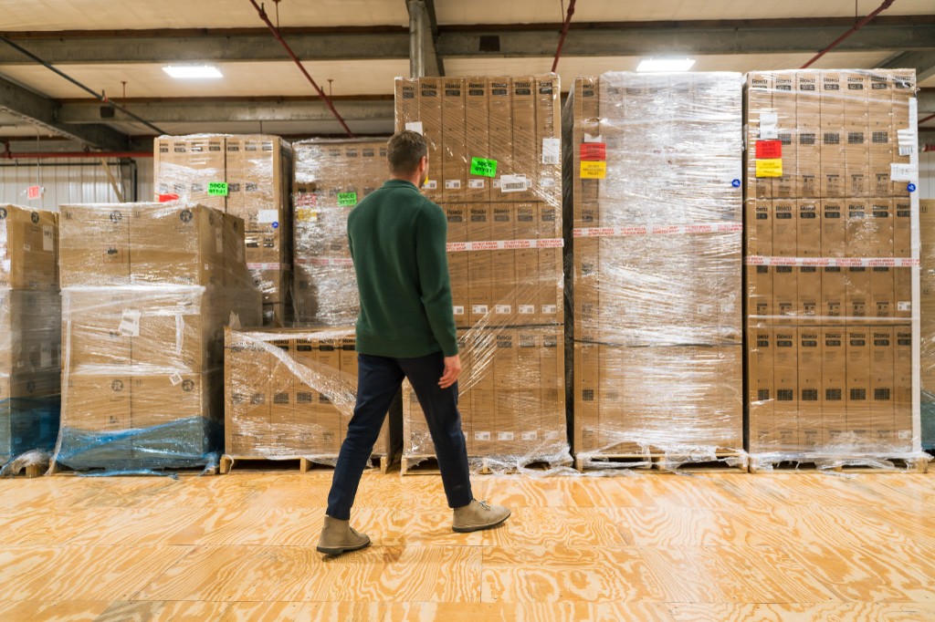 Operations team member on the warehouse floor beside inventory